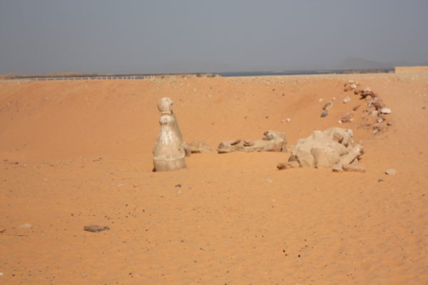 Statues covered by sand in Egypt