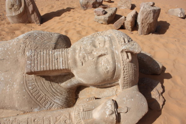 Statue of Rameses II with a missing nose and damaged face